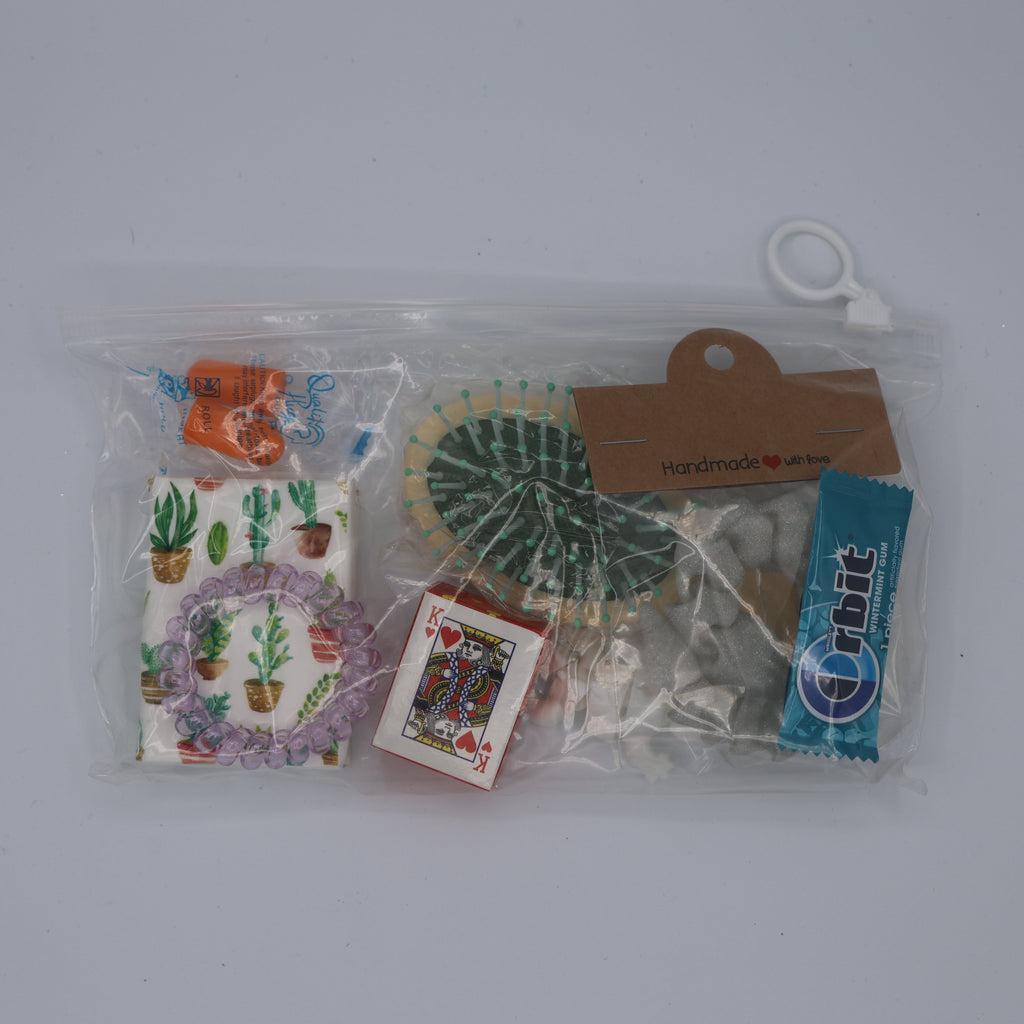 Collection of small items including a plastic bag with printed designs and cards