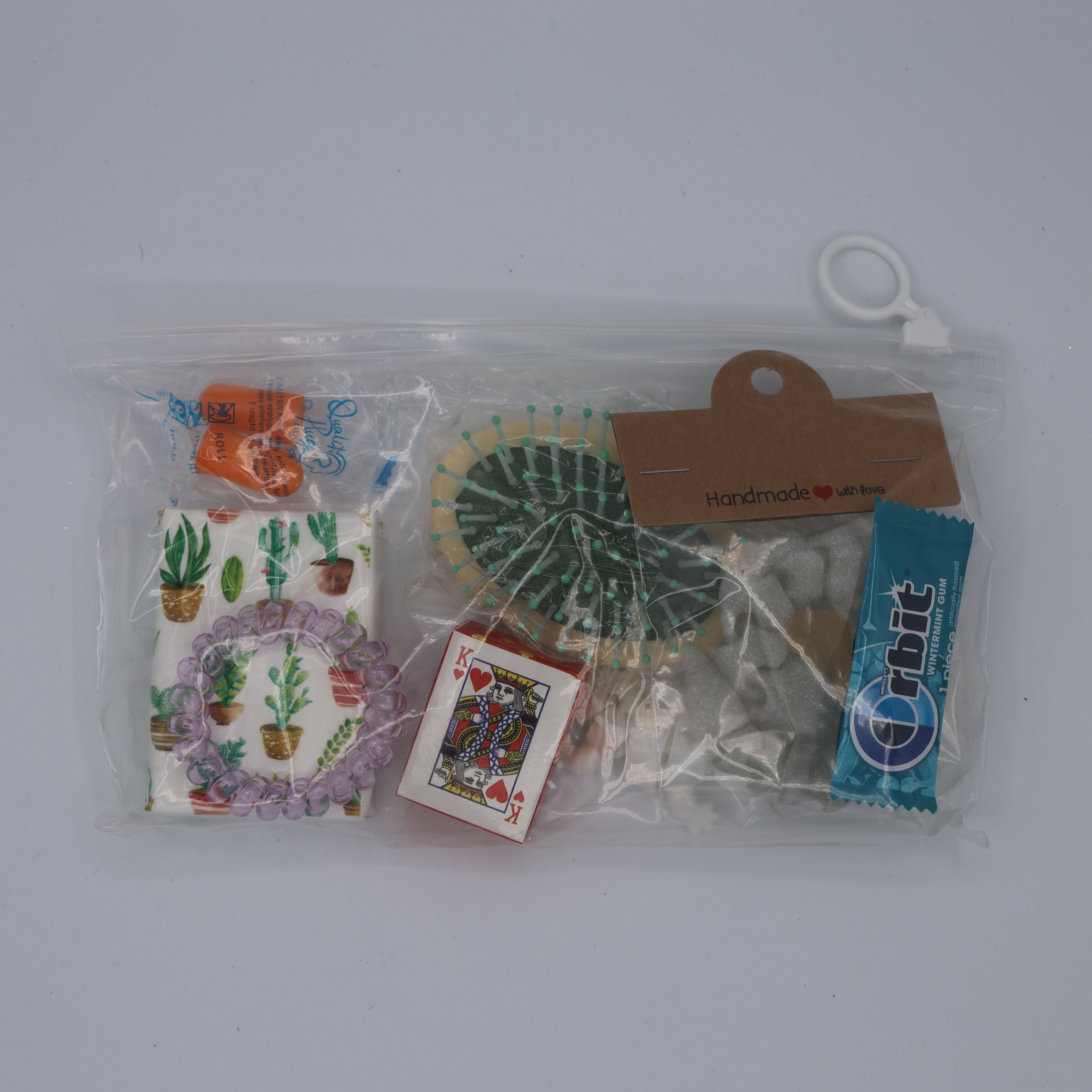 Collection of small items including a plastic bag with printed designs and cards