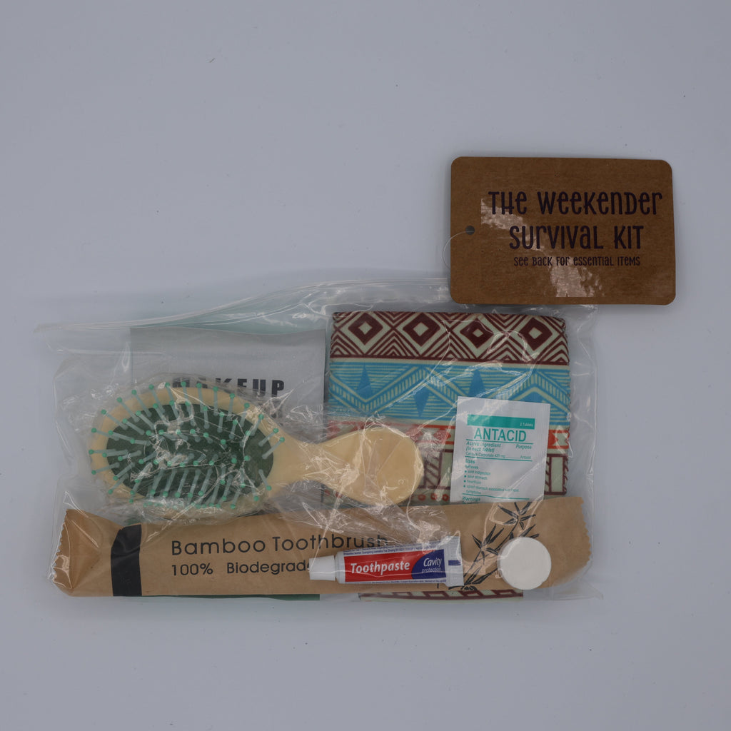 Weekender survival kit with various items including a hairbrush, toothbrush, toothpaste, antacid, ect.